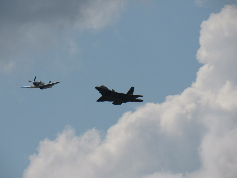 Then & Now: a P-51 Mustang flying with an F-22 Raptor.
